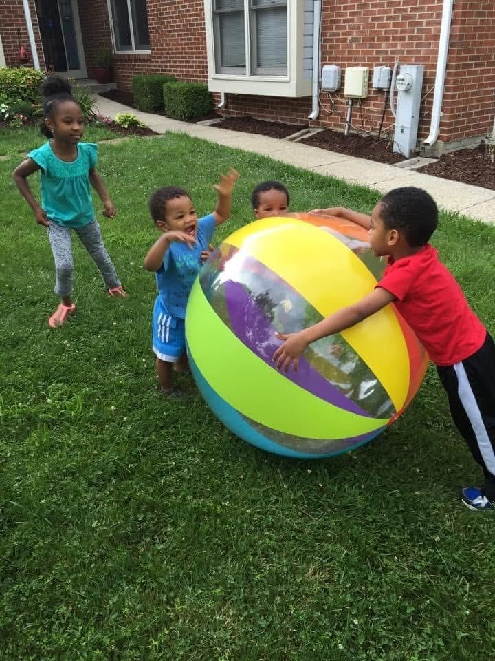 Children playing together with a giant beach ball Children playing together with a giant beach ball
