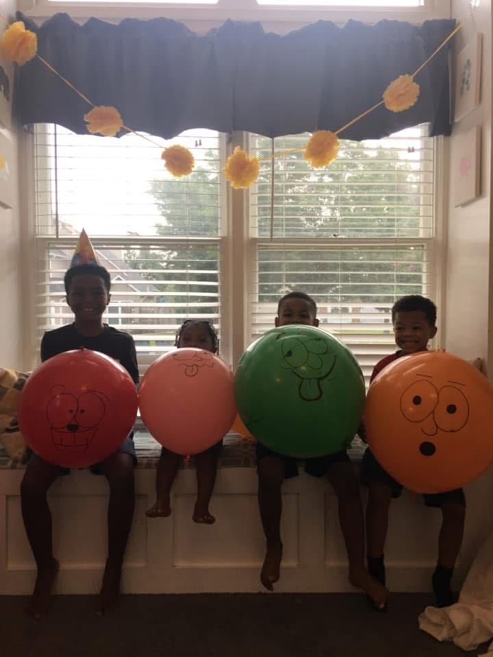 Children holding decorated balloons at Lisa's Rascals Daycare Children holding decorated balloons at Lisa's Rascals Daycare