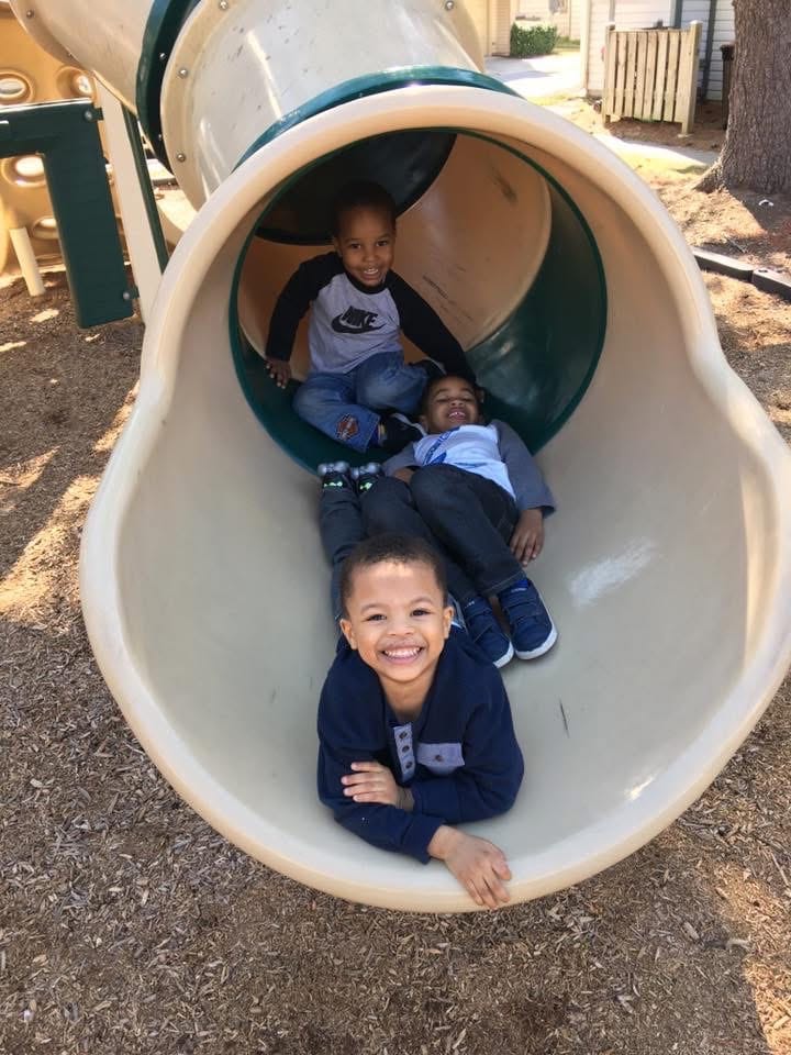 Children playing on a tube slide at Lisa's Rascals Daycare Children playing on a tube slide at Lisa's Rascals Daycare