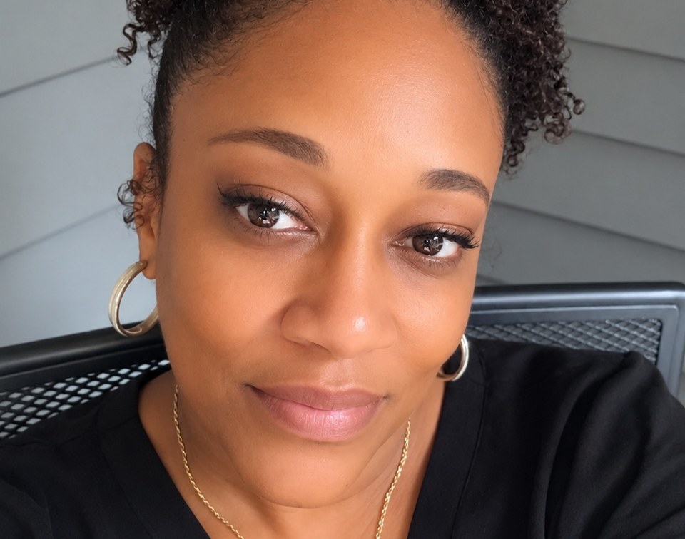 Lisa Williams smiling, founder and licensed family childcare provider at Lisa's Rascals Daycare in Laurel, MD