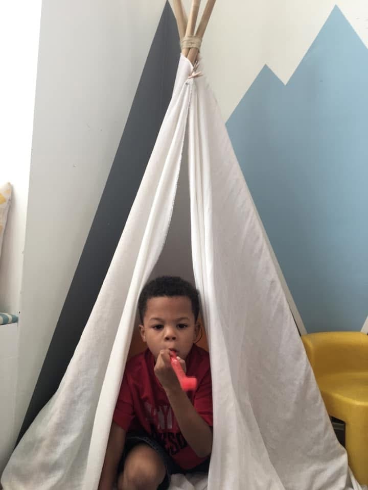 A child relaxing in a reading teepee at Lisa's Rascals Daycare A child relaxing in a reading teepee at Lisa's Rascals Daycare